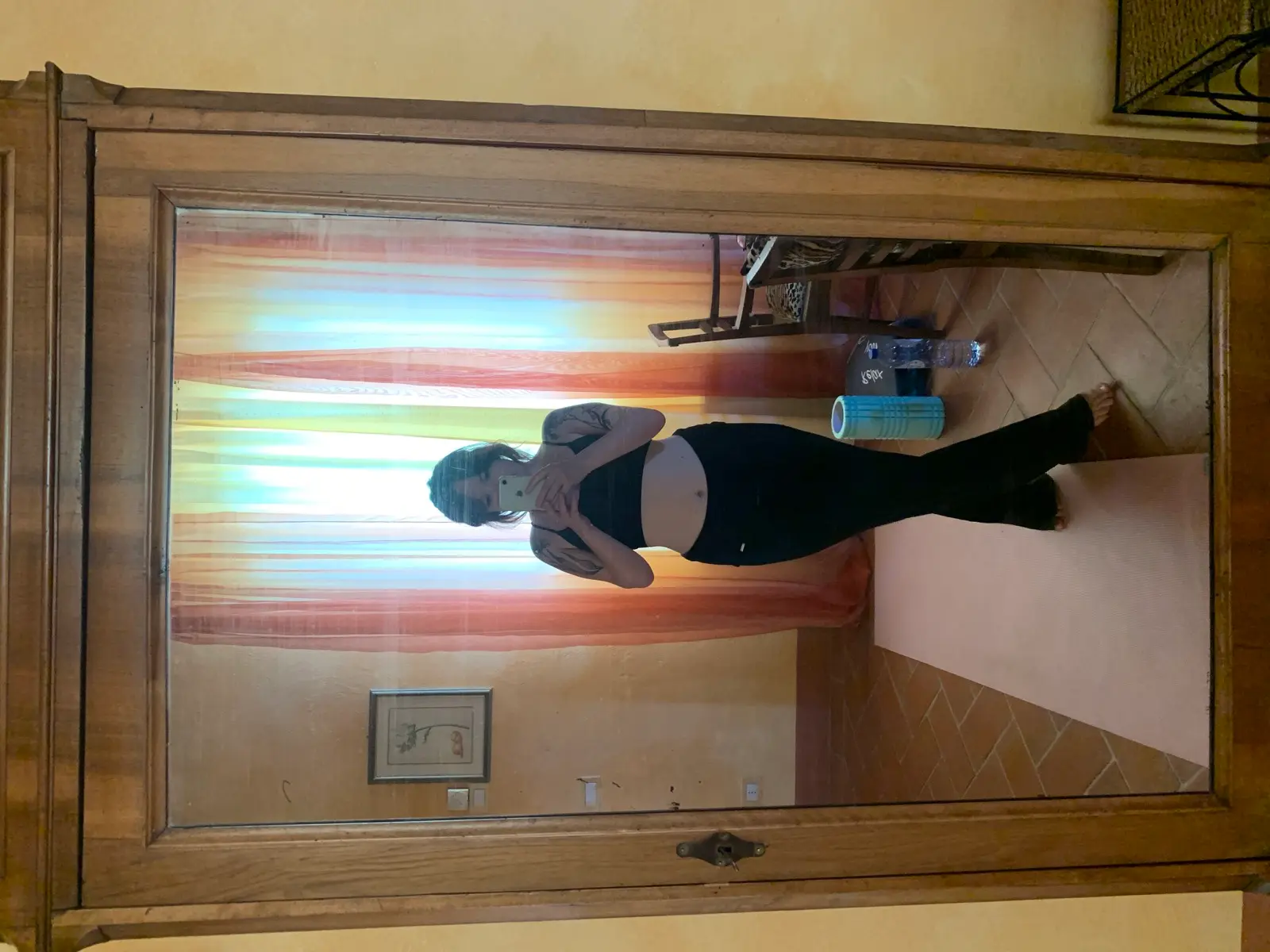 Lucy's mirror selfie in workout clothes, phone covering her face